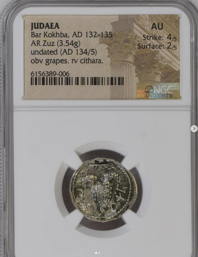Year 3 of the Revolt (AD 134/5) AR Zuz (3.54g) - obverse: bunch of grapes / reverse: cithara (lyre) - struck over a Roman Imperial denarius - obverse