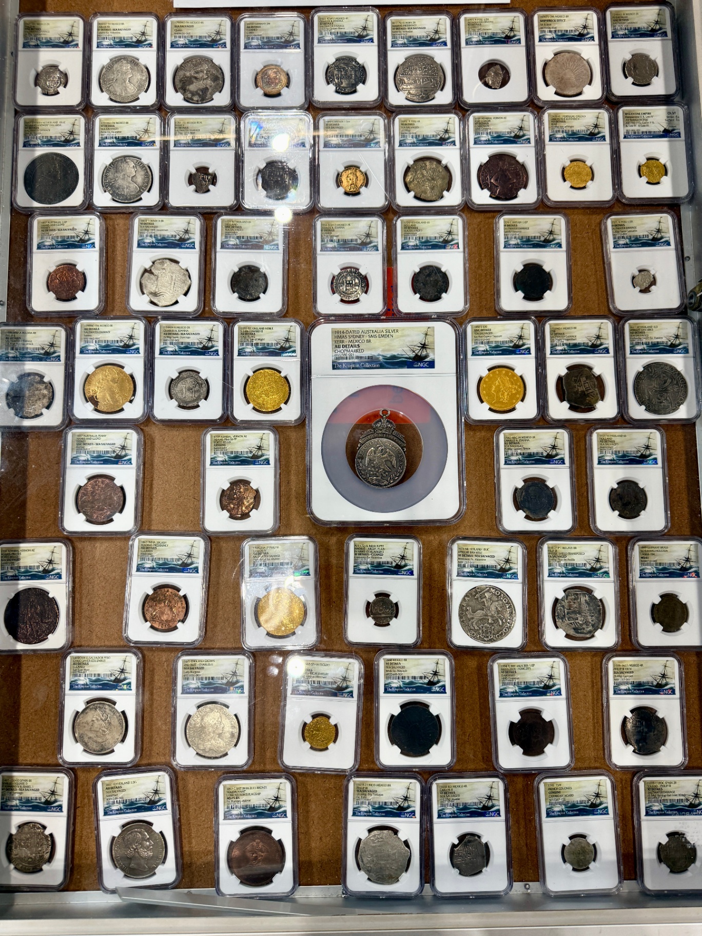 A tray showing a portion of The Knapton Collection - dozens of NGC-certified shipwreck coins in their slabs